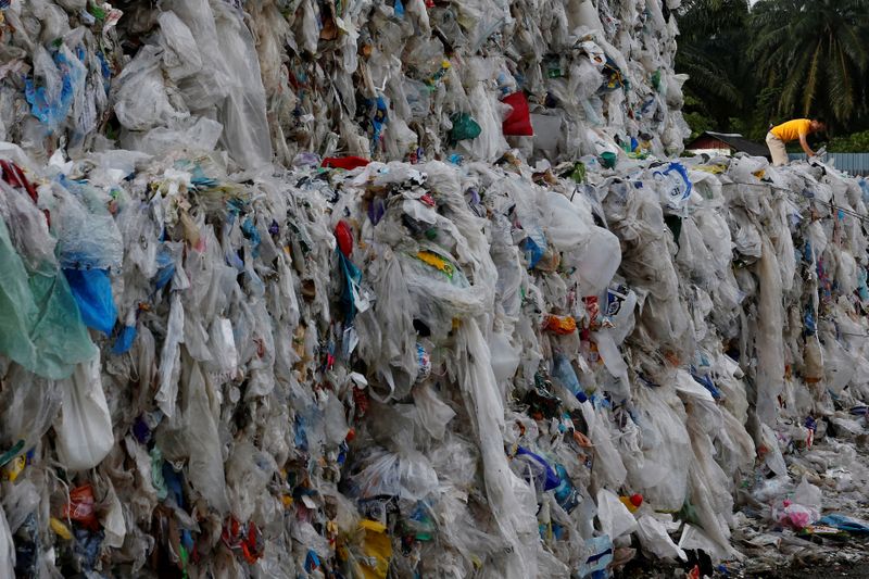 FILE PHOTO: Plastic waste are piled outside an illegal recycling