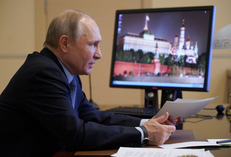 Russian President Vladimir Putin chairs a meeting outside Moscow