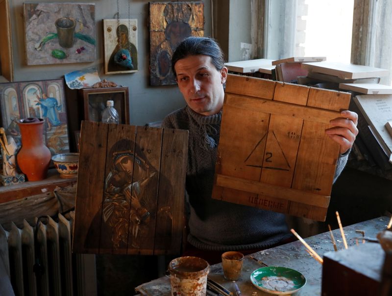 Ukrainian artist Oleksandr Klymenko shows his artwork and part of