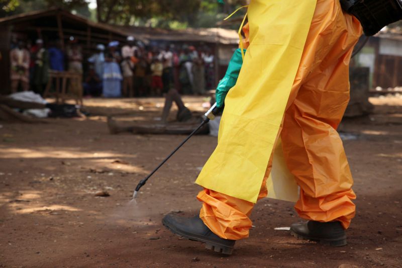 FILE PHOTO: A member of the French Red Cross disinfects