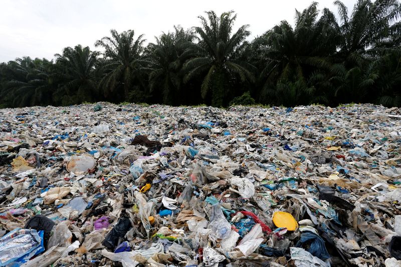 FILE PHOTO: Plastic waste piled outside an illegal recycling factory
