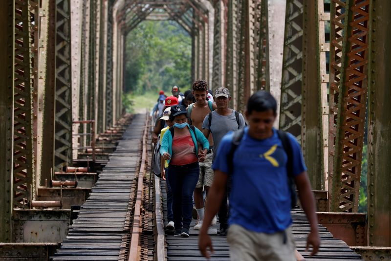 FILE PHOTO: A group of migrants from Honduras walk along
