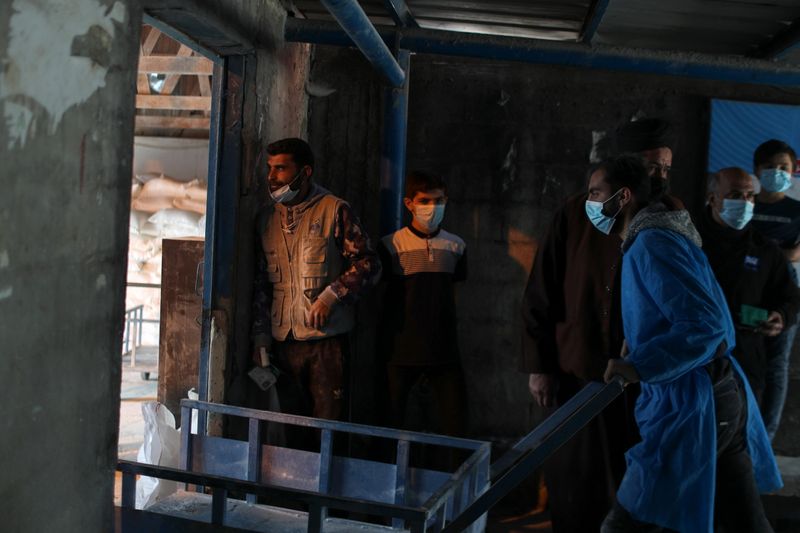 Palestinians receive food supplies at UNRWA distribution center in Gaza