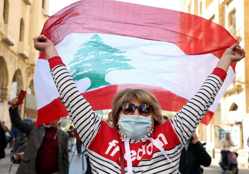 FILE PHOTO: A demonstrator holds up a national flag during