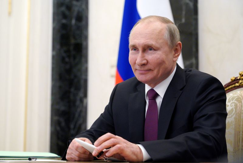 FILE PHOTO: Russian President Vladimir Putin takes part in a
