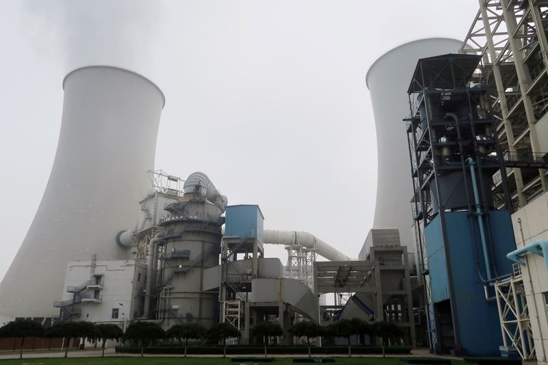 FILE PHOTO: Water vapour rises from a cooling tower of