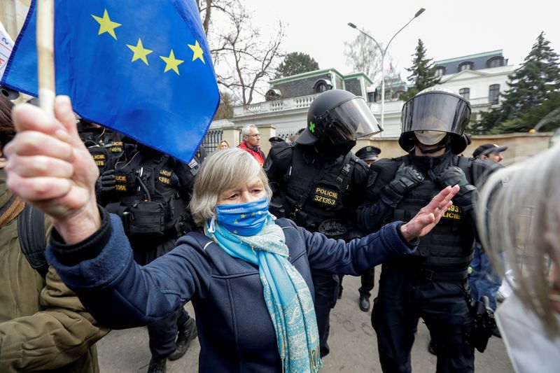 FILE PHOTO: A woman holds an EU flag next to