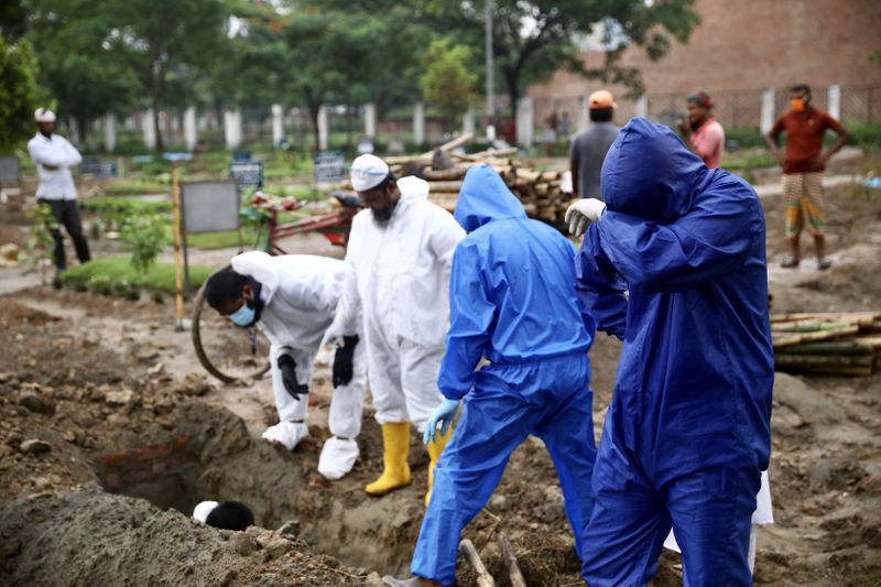 A relative wearing protective suit reacts while burying the body