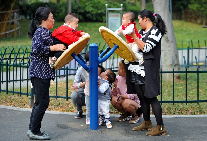 Women play with children at a park in Jinhua, Zhejiang