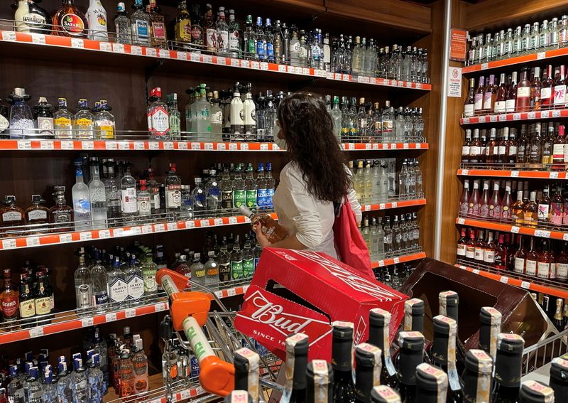 A customer shops for alcoholic beverages at a supermarket in
