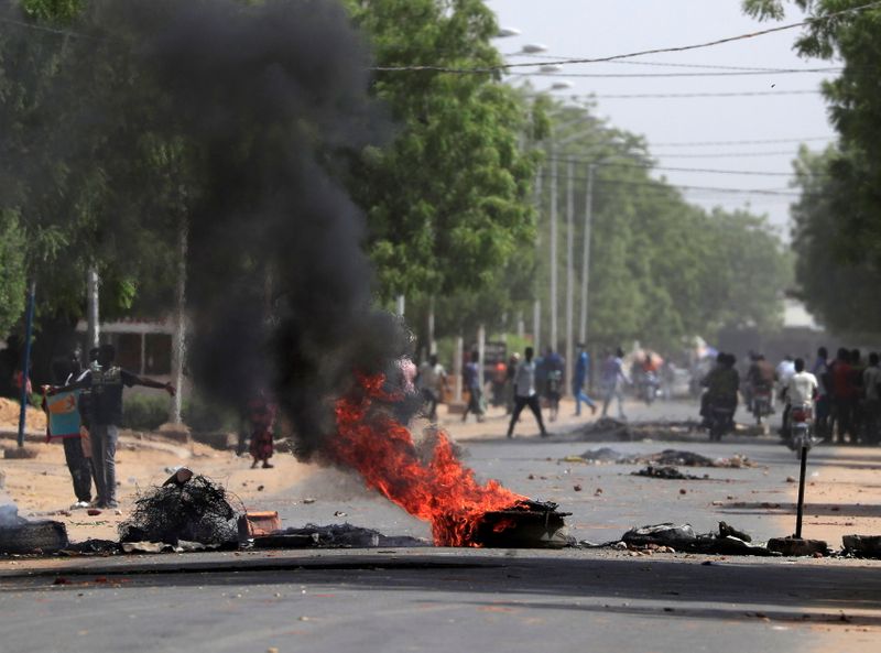 FILE PHOTO: Tires burn at a barricade during protests demanding