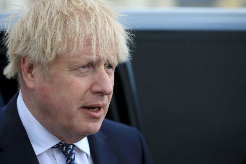 Britain’s Prime Minister Boris Johnson looks on as he campaigns