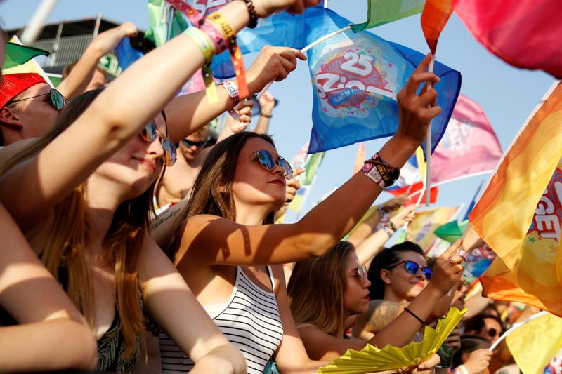 Festivalgoers attend a flag party during Sziget music festival on