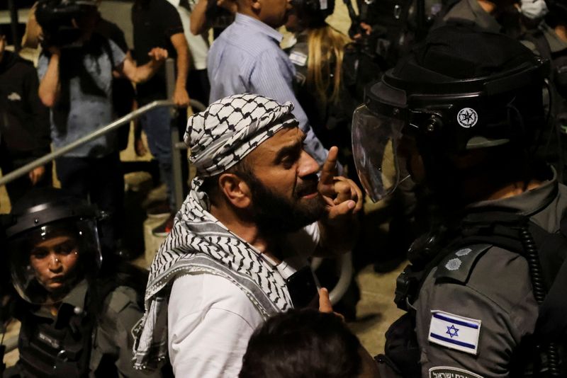 A Palestinian man gestures as he argues with an Israeli