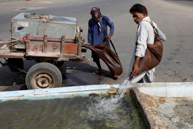 A traditional mashki delivers water in goatskin bags in Karachi
