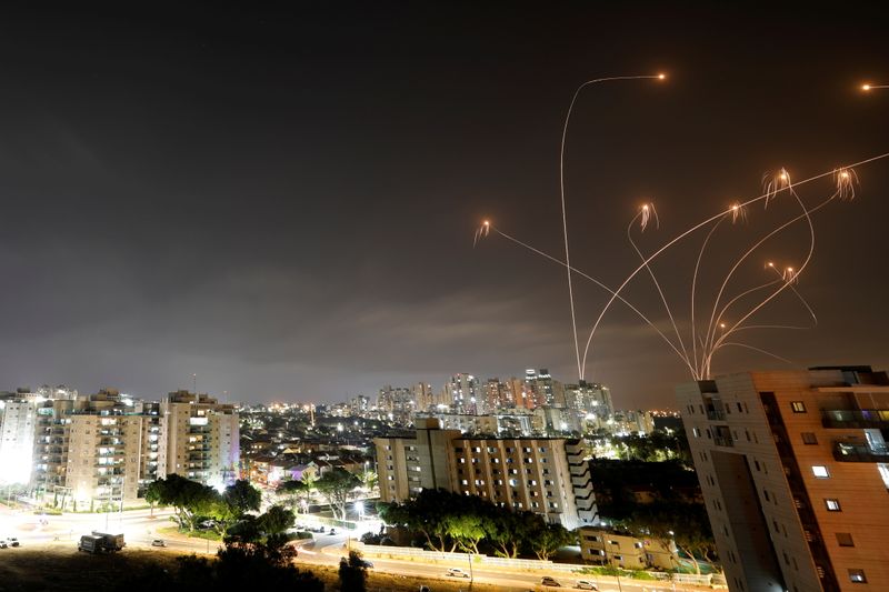 Streaks of light are seen as Israel’s Iron Dome anti-missile