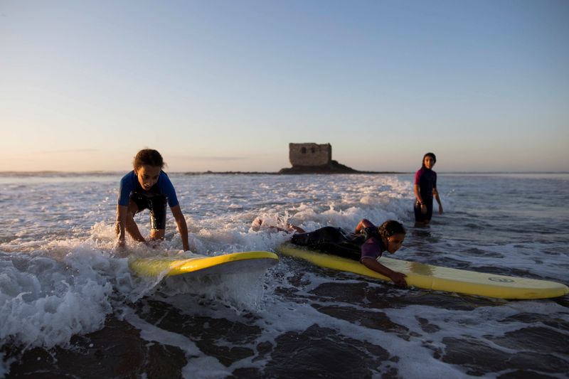 The Wider Image: On the edge of Moroccan desert, surfers