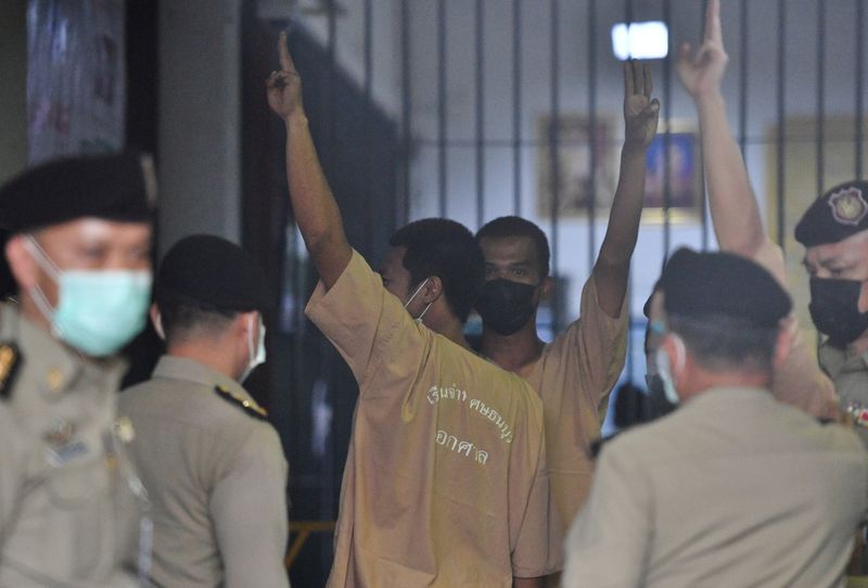 FILE PHOTO: Arrested anti-government protesters arrive at criminal court to