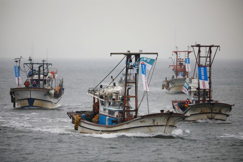 FILE PHOTO: South Korean fishing boats take part in a