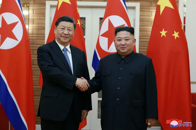 North Korean leader Kim Jong Un shakes hands with China’s