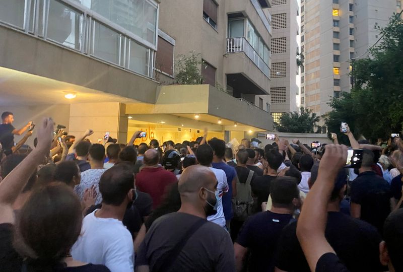 Demonstrators protest outside the home of the caretaker interior minister