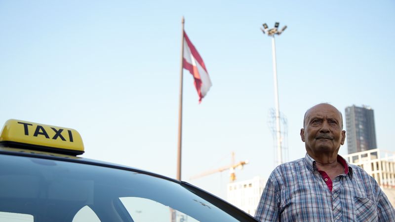 Lebanese flag flutters as Zakaria Ghalayeeni, 76-year-old Lebanese taxi driver,