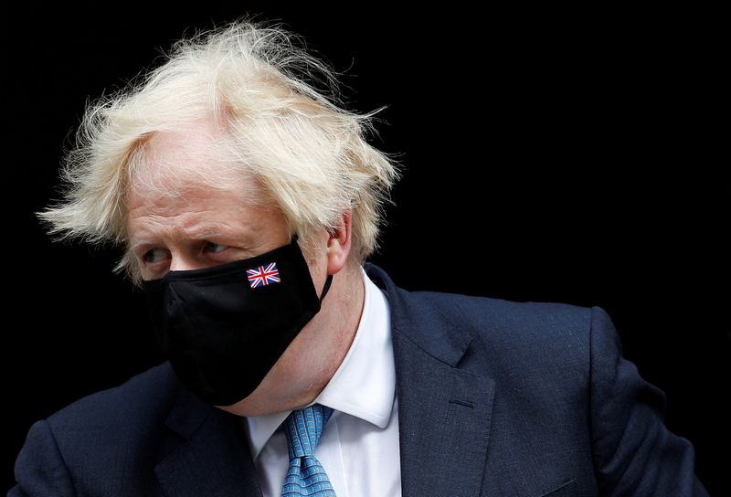 FILE PHOTO: Britain’s PM Johnson walks on Downing Street in