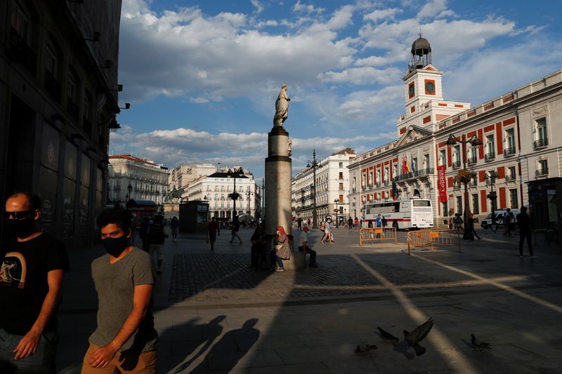 People hang out at Madrid’s landmark Puerta del Sol square