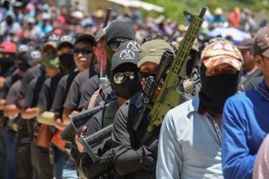Vigilantes of “El Machete” are seen during an assembly with