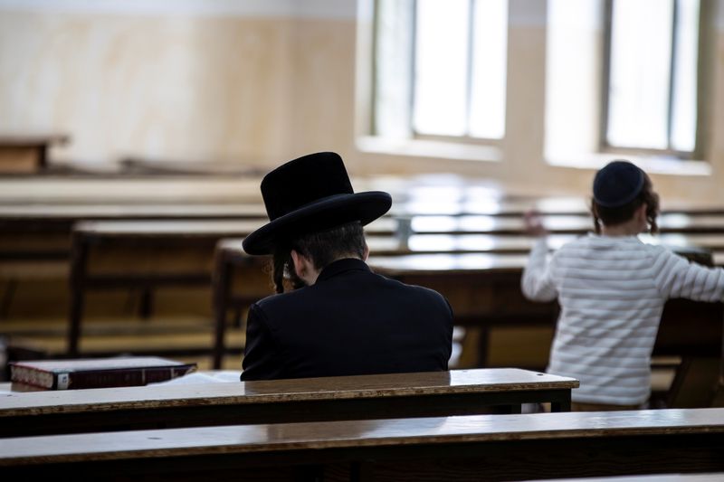 An Ultra Orthodox Jewish man sits in a religious study