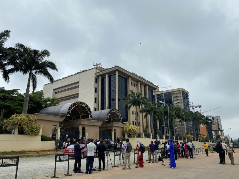 Journalists are seen stationed opposite the Federal High Court as