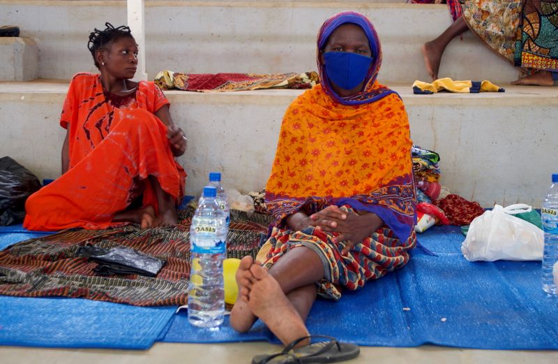 FILE PHOTO: Displaced women sit on mats, at a displacement