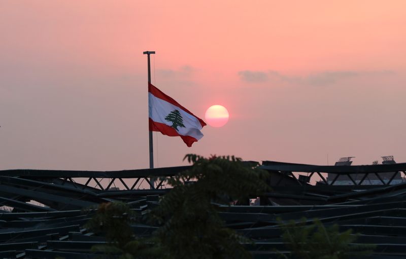 Lebanese flag flutters at the site of last year’s Beirut