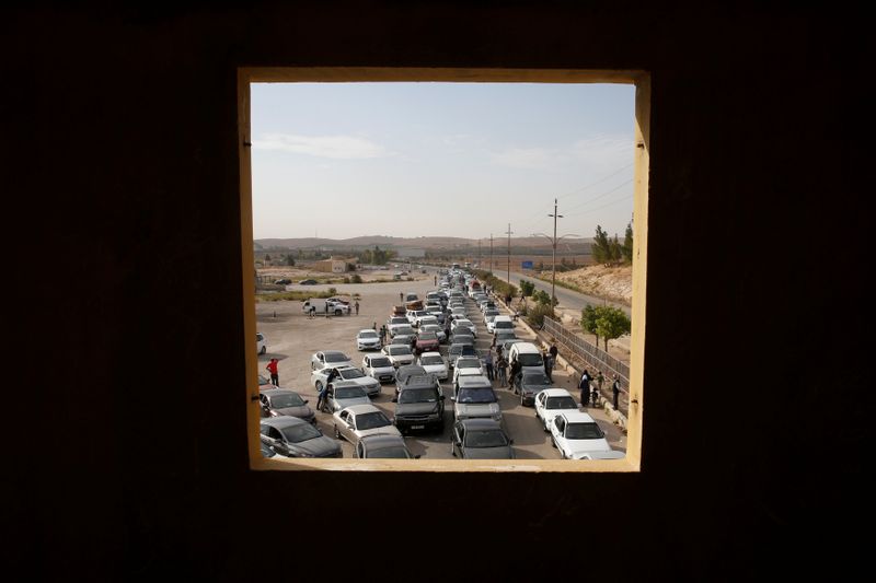 FILE PHOTO: People wait to travel to Syria at Jordan’s
