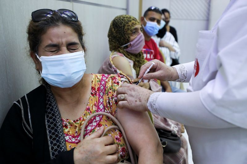 A woman receives the COVID-19 vaccine at a vaccination center