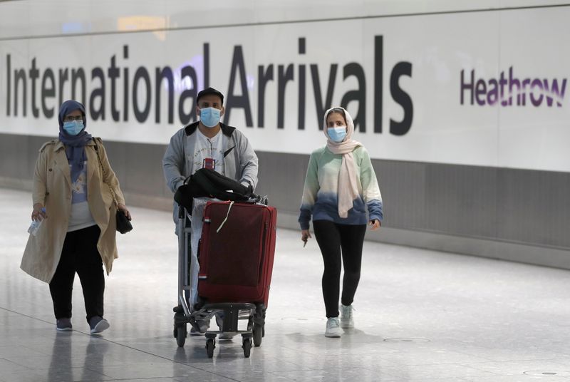 Passengers walk through the International arrivals area of Terminal 5