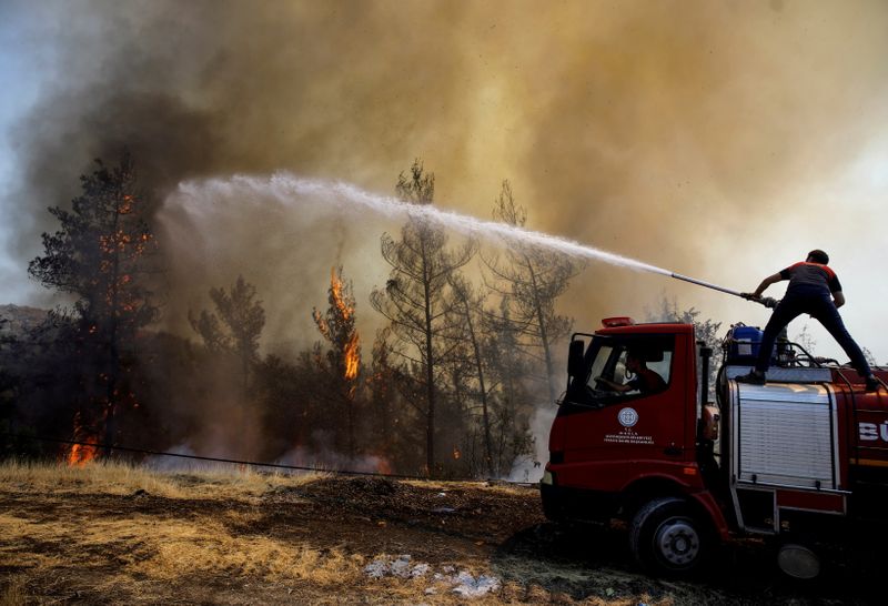FILE PHOTO: A firefighter tries to extinguish a wildfire near
