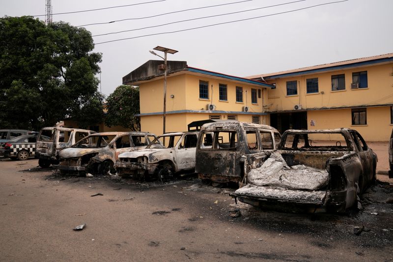 FILE PHOTO: Burnt vehicles are seen outside the Nigeria police