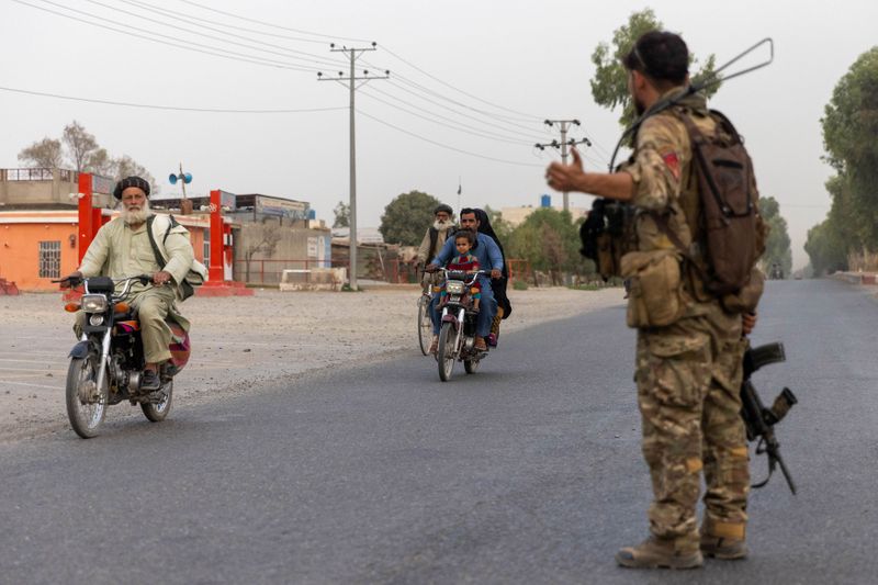 A member of the Afghan Special Forces directs traffic during