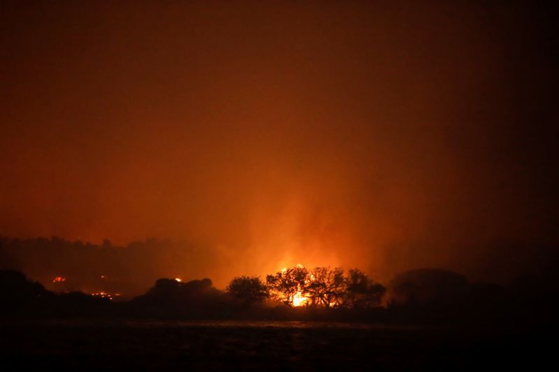FILE PHOTO: Bodrum’s night sky turns orange as Turkey’s wildfires