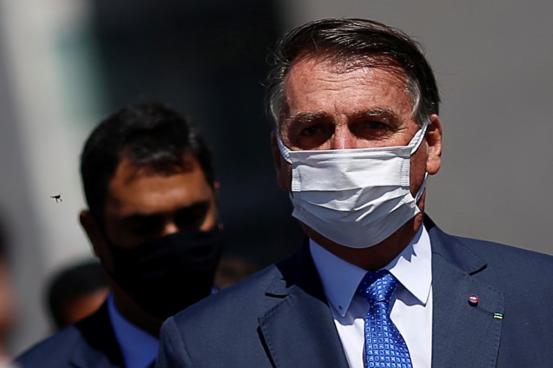 Brazil’s President Jair Bolsonaro walks after a meeting to deliver
