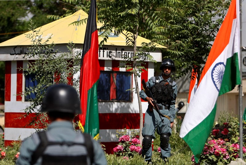FILE PHOTO: Afghan policemen stand guard next to Indian and