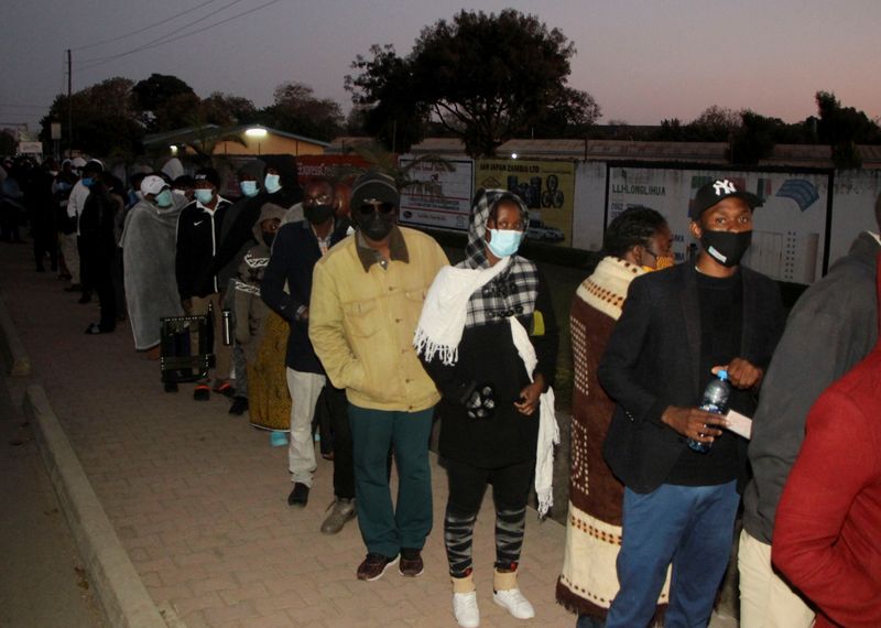 Voters queue to cast their ballots during national elections, in