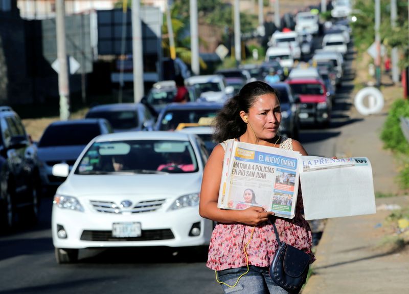 FILE PHOTO: A street vendor sells La Prensa, a local