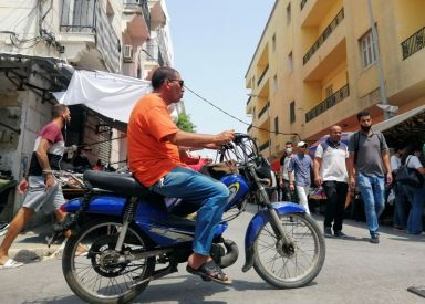 A man rides a motorbike in Tunis