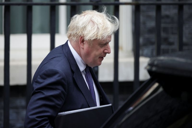 Britain’s PM Boris Johnson walks outside Downing Street in London