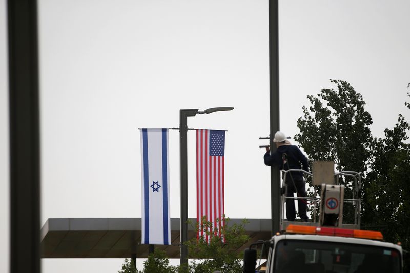 Israeli and U.S. flags hang next to the entrance to