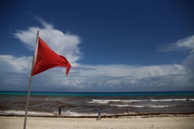 FILE PHOTO: A red flag on the beach warns beachgoers