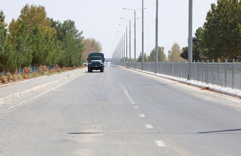 A vehicle drives near a checkpoint at the Uzbekistan-Afghanistan border