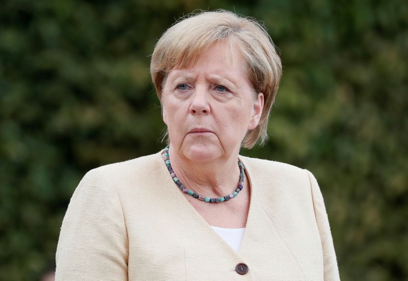 German Chancellor Angela Merkel takes part in a wreath-laying ceremony